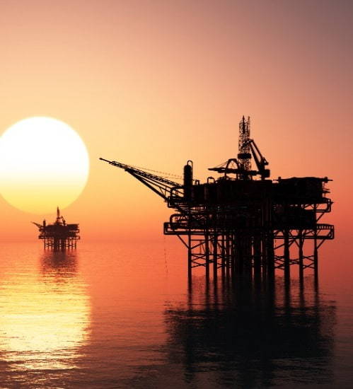 Image of an oil rig at sunset 