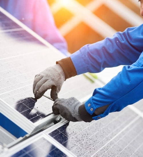 close up of someones hands installing a solar panel 