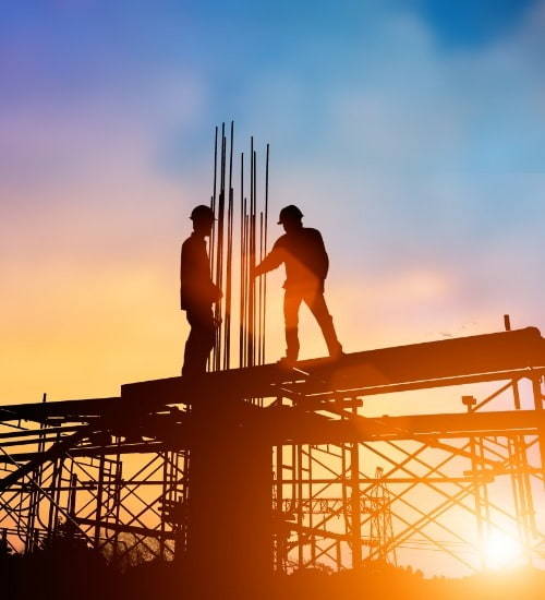 2 people on top of scaffolding with sunset background
