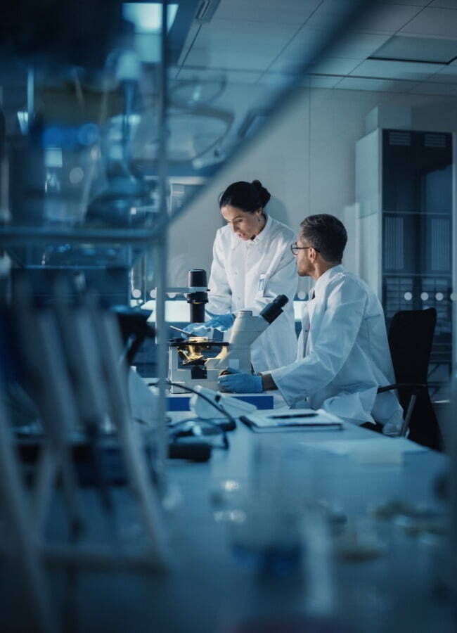 Man and woman reviewing something in lab