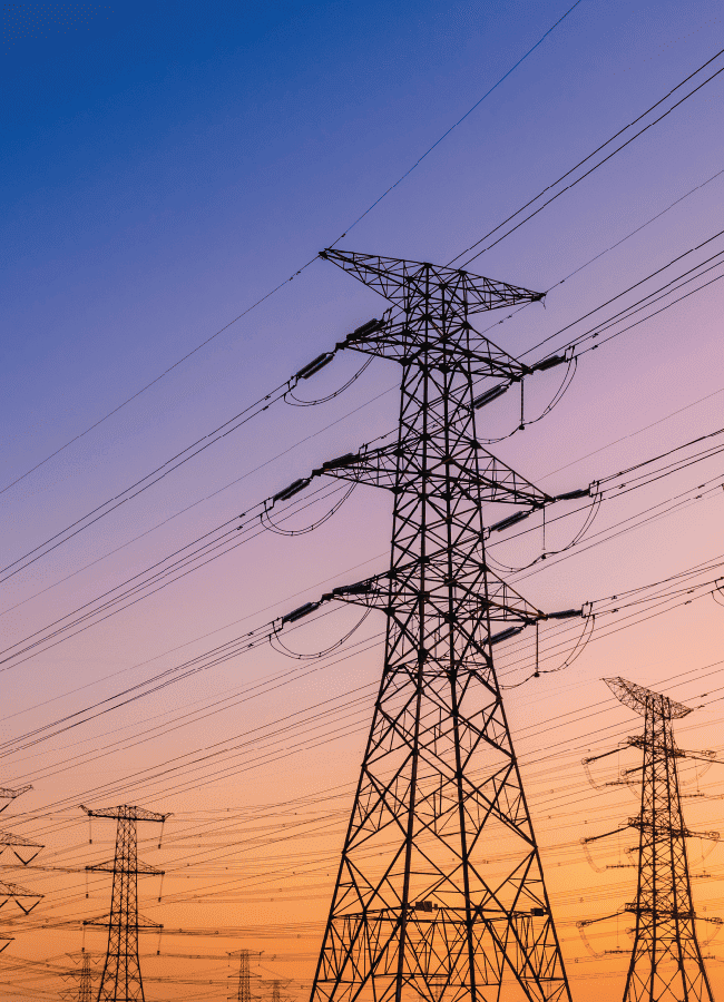 electricity tower against sunset