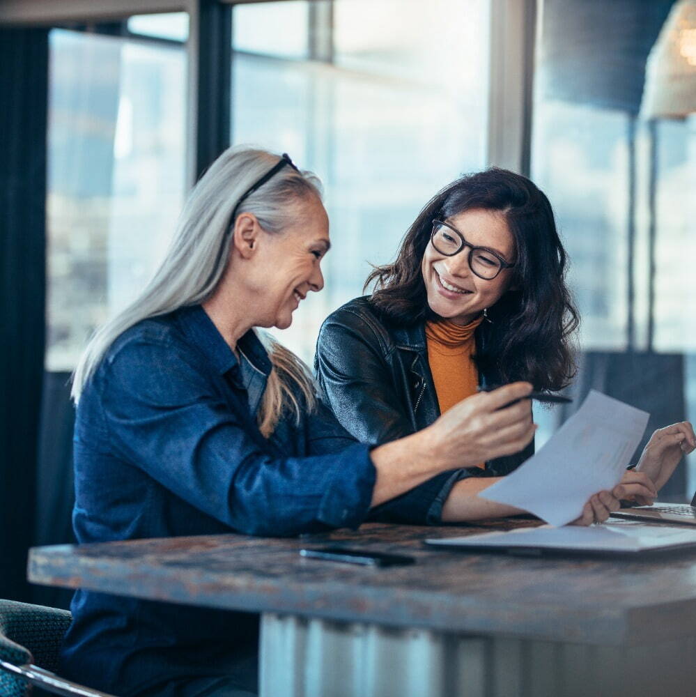 woman speaking to another woman 