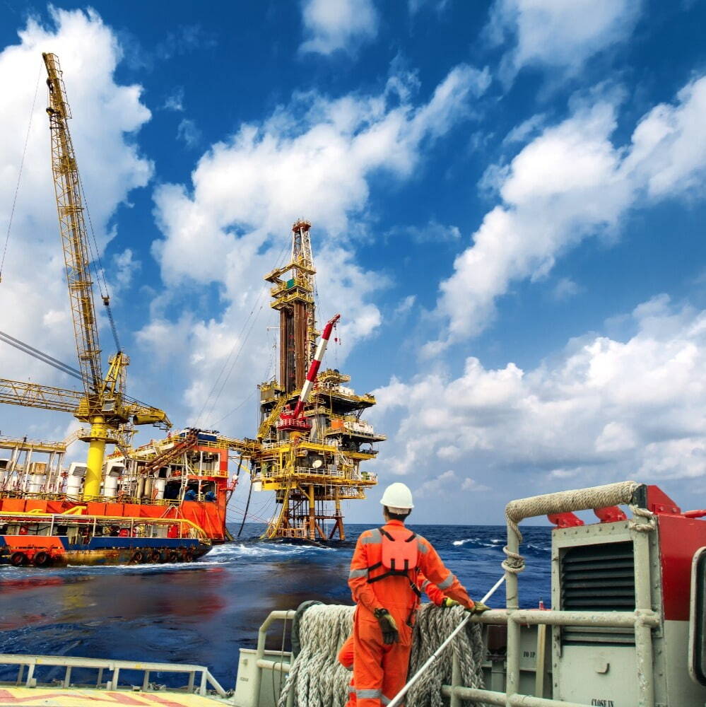 Technician on crew boat transferring to offshore oil and gas platform
